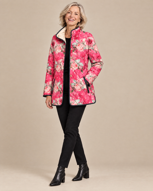 Woman posing in the Freya pink floral print quilted jacket