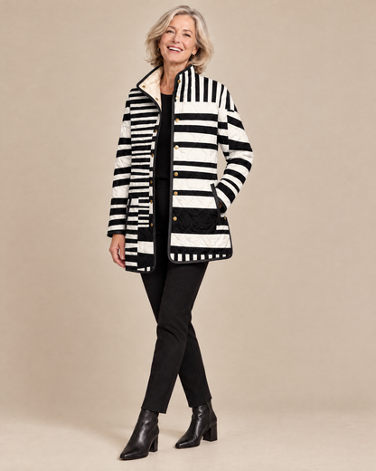 Woman posing in the Miren black and white abstract quilted jacket