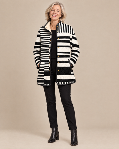 Woman wearing the Miren black and white abstract quilted jacket, front view
