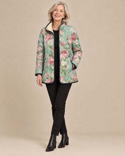 Woman wearing the Carys retro floral patterned quilted jacket, front view