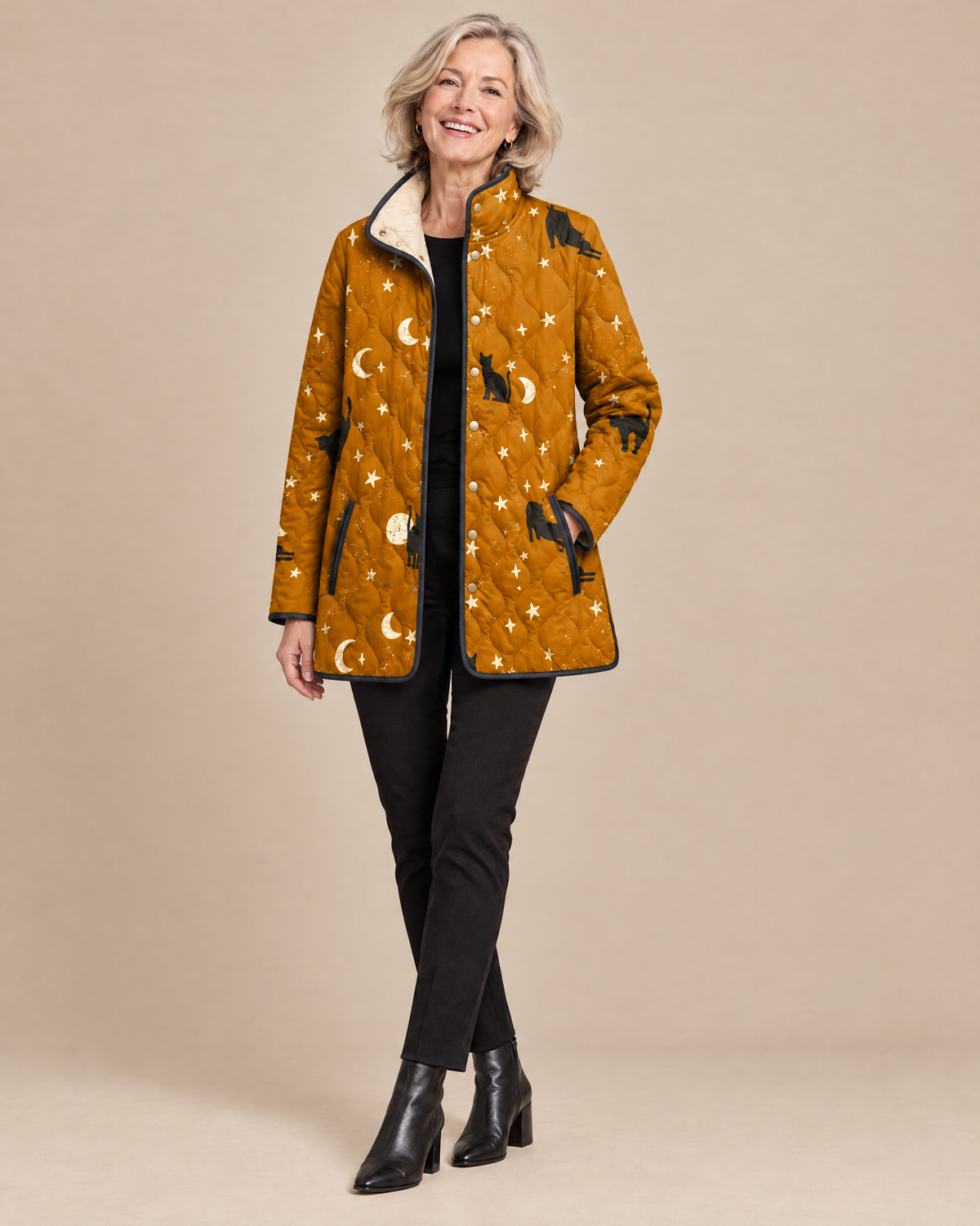 Woman wearing the Maya black quilted jacket with cat pattern, front view