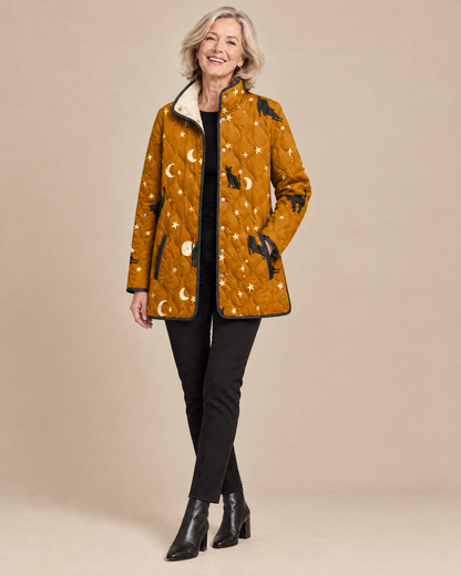 Woman wearing the Maya black quilted jacket with cat pattern, front view
