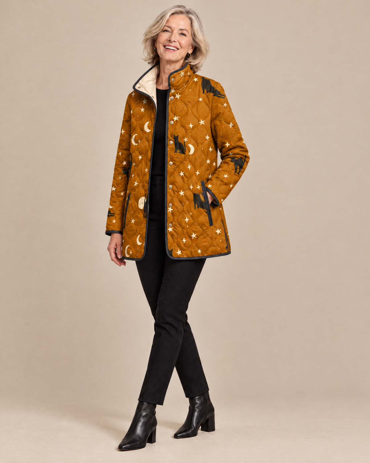 Woman posing in the Maya black quilted jacket with cat pattern
